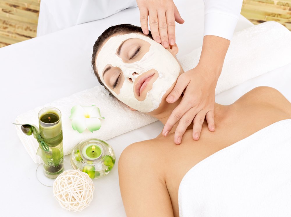 young-woman-at-spa-salon-with-cosmetic-mask-on-face-high-angle-photo
